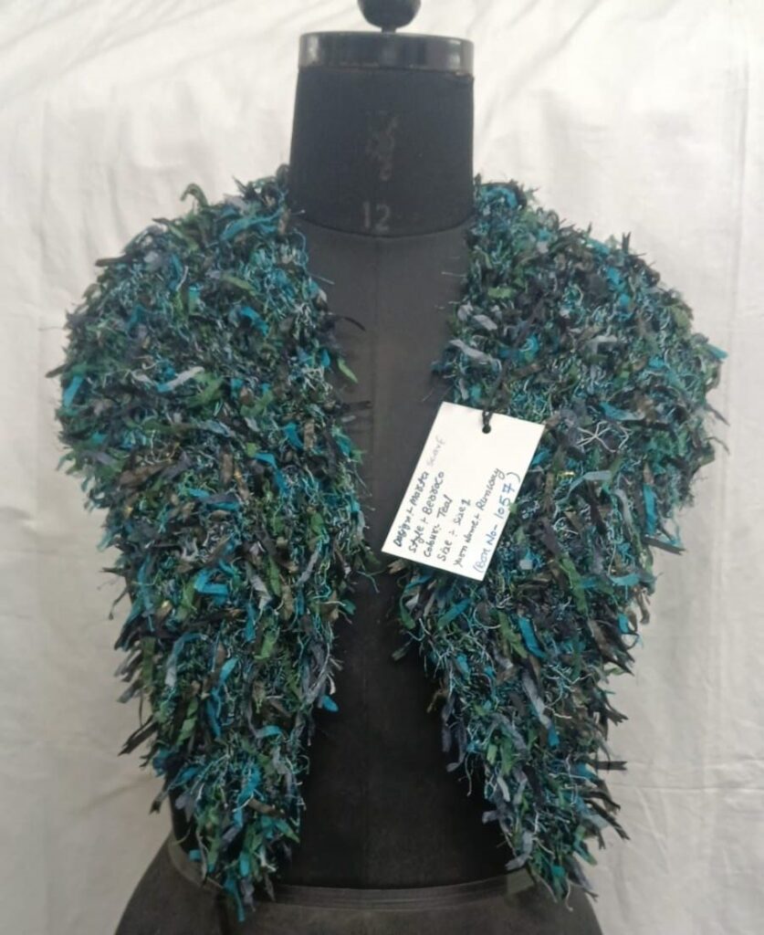 Handmade blue and green textured scarf displayed on a mannequin.